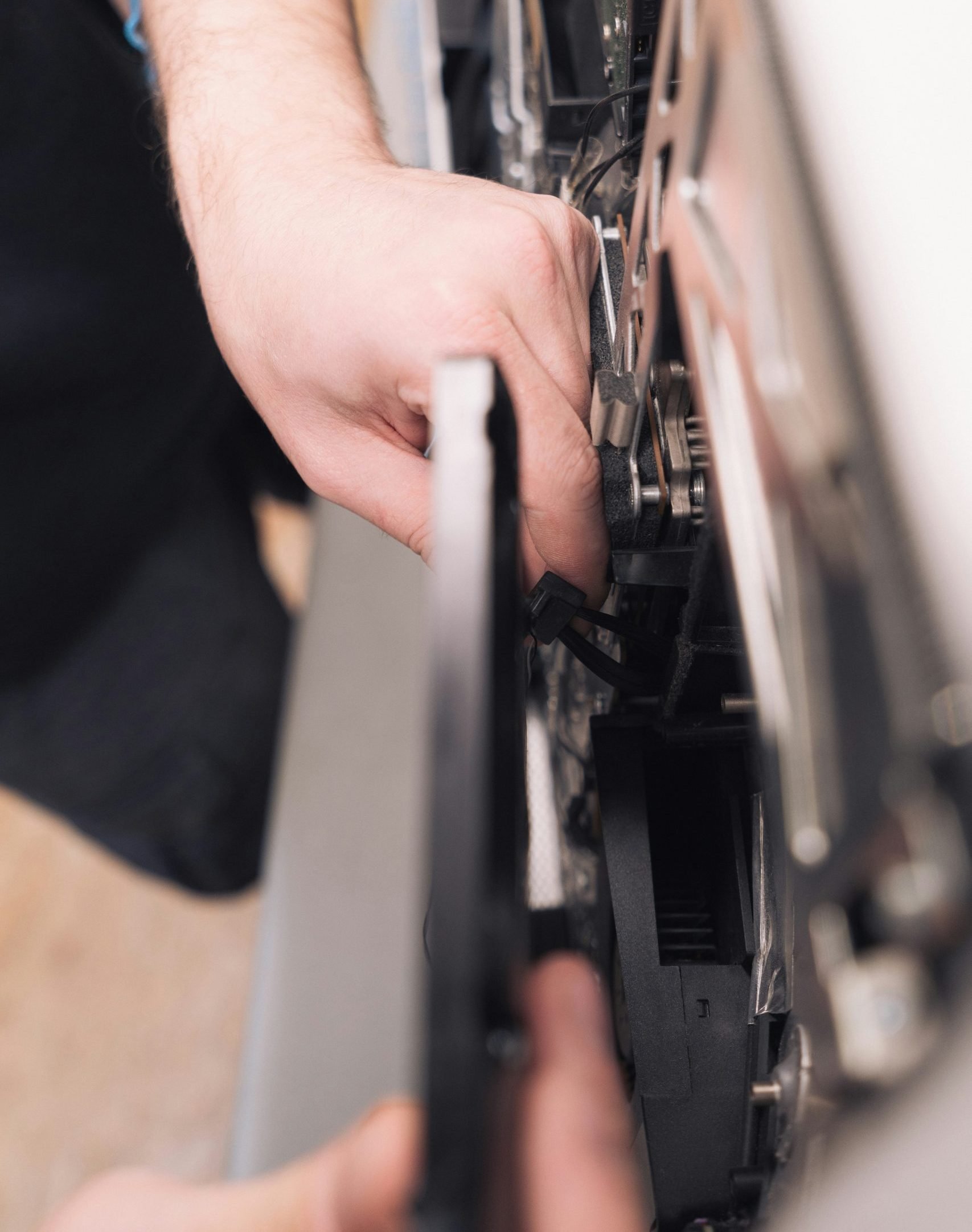 Technician repairing appliance components, emphasizing hands-on service in appliance repair industry.