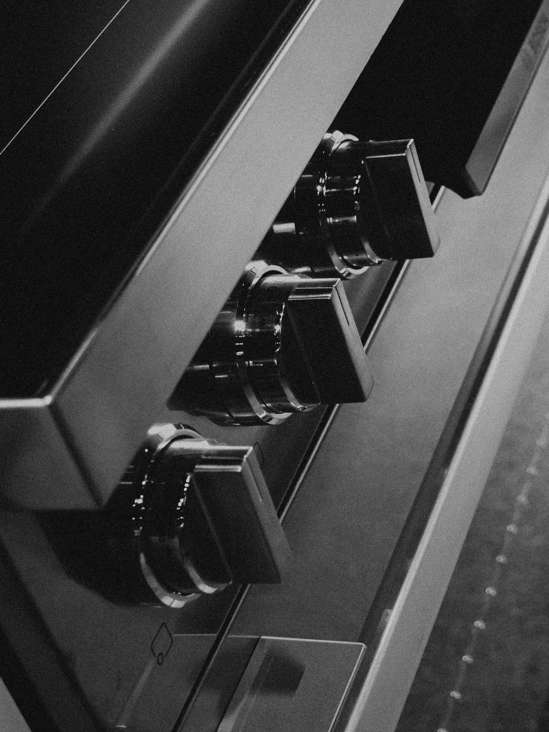 Close-up of appliance control knobs on a black stove, highlighting features relevant for appliance repair evaluation and service agreements.
