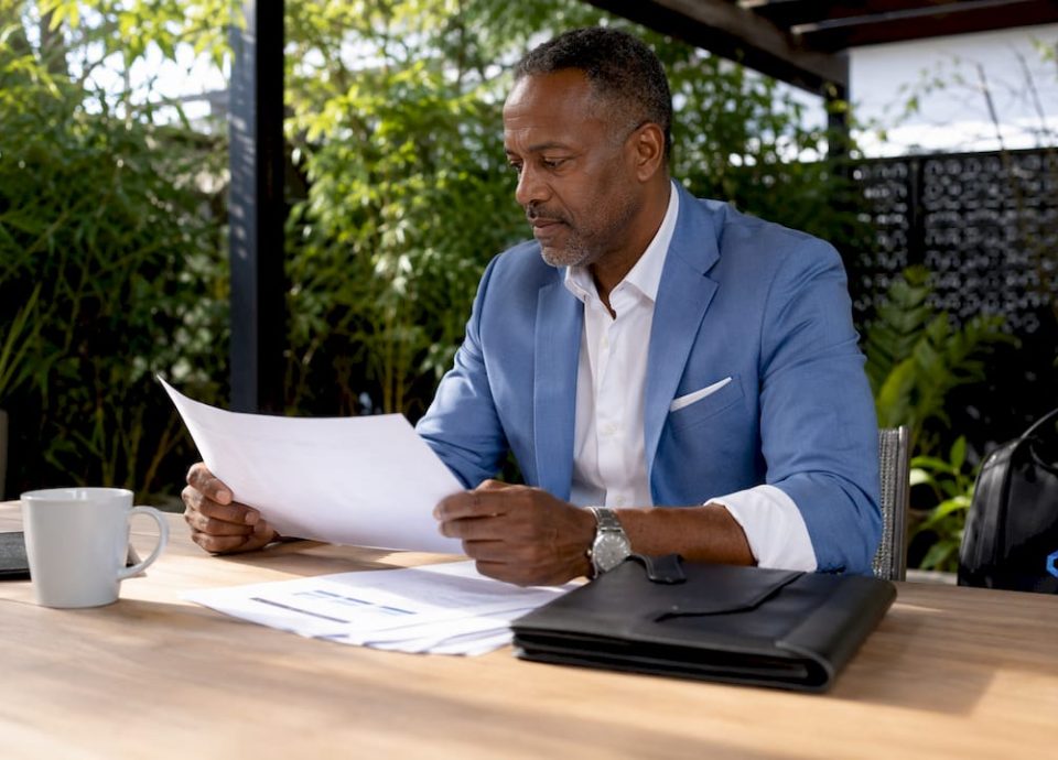 Business advisor reviewing deal profiles in office