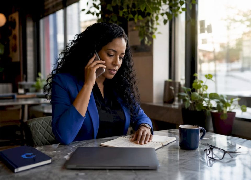Woman making cold outreach call in office