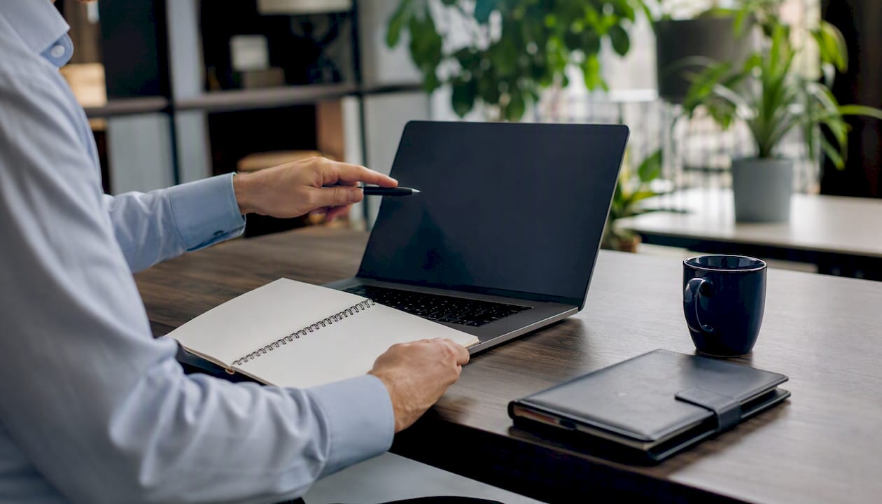 Advisor pointing at dark laptop screen