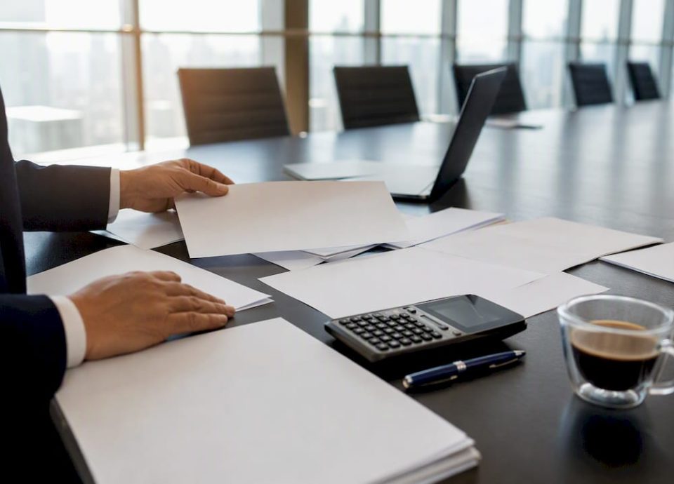 Hands calculating purchase price allocation