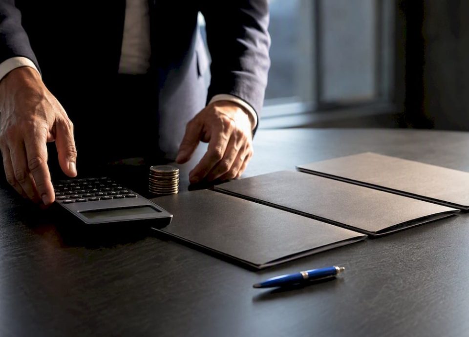 Hands organizing business valuation materials