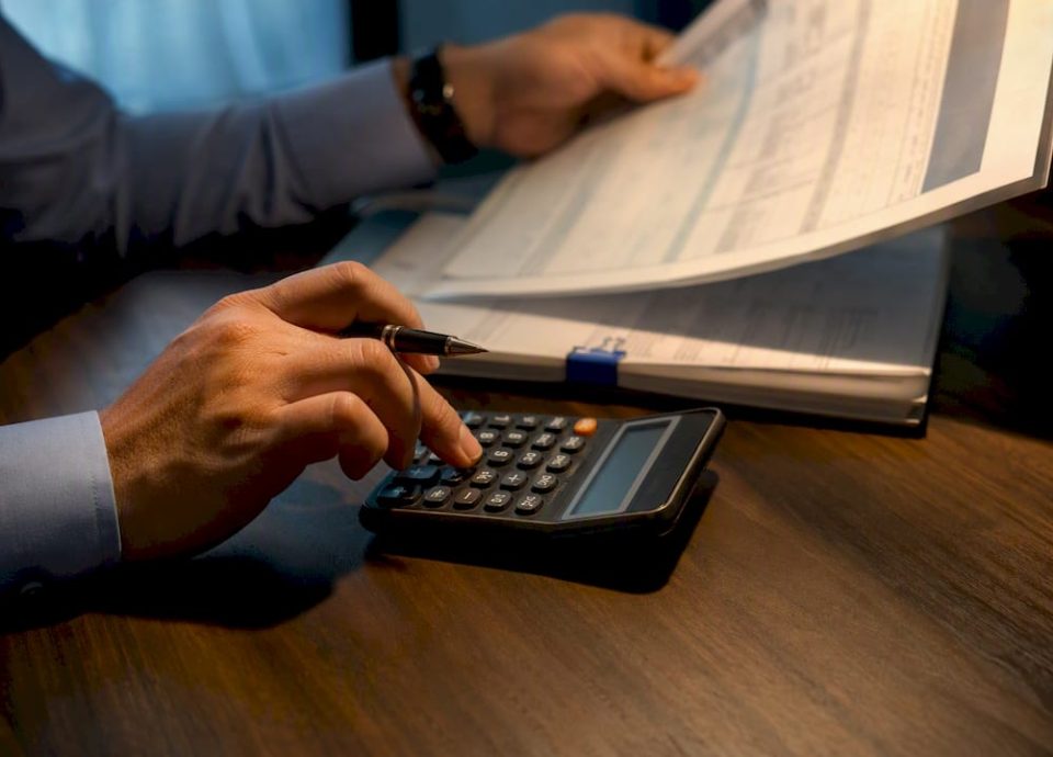 Analyst reconciling financial records for QoE